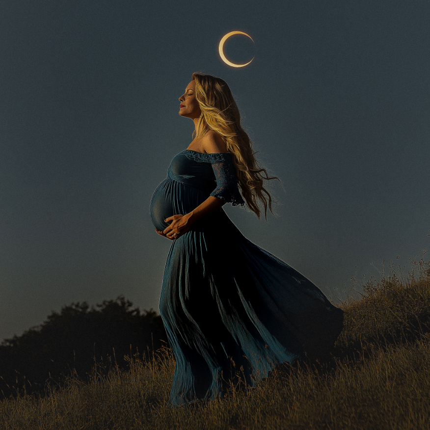 Pregnant woman in a flowing blue dress stands on grassy hill at dusk, with an eclipse in the dark sky above her.